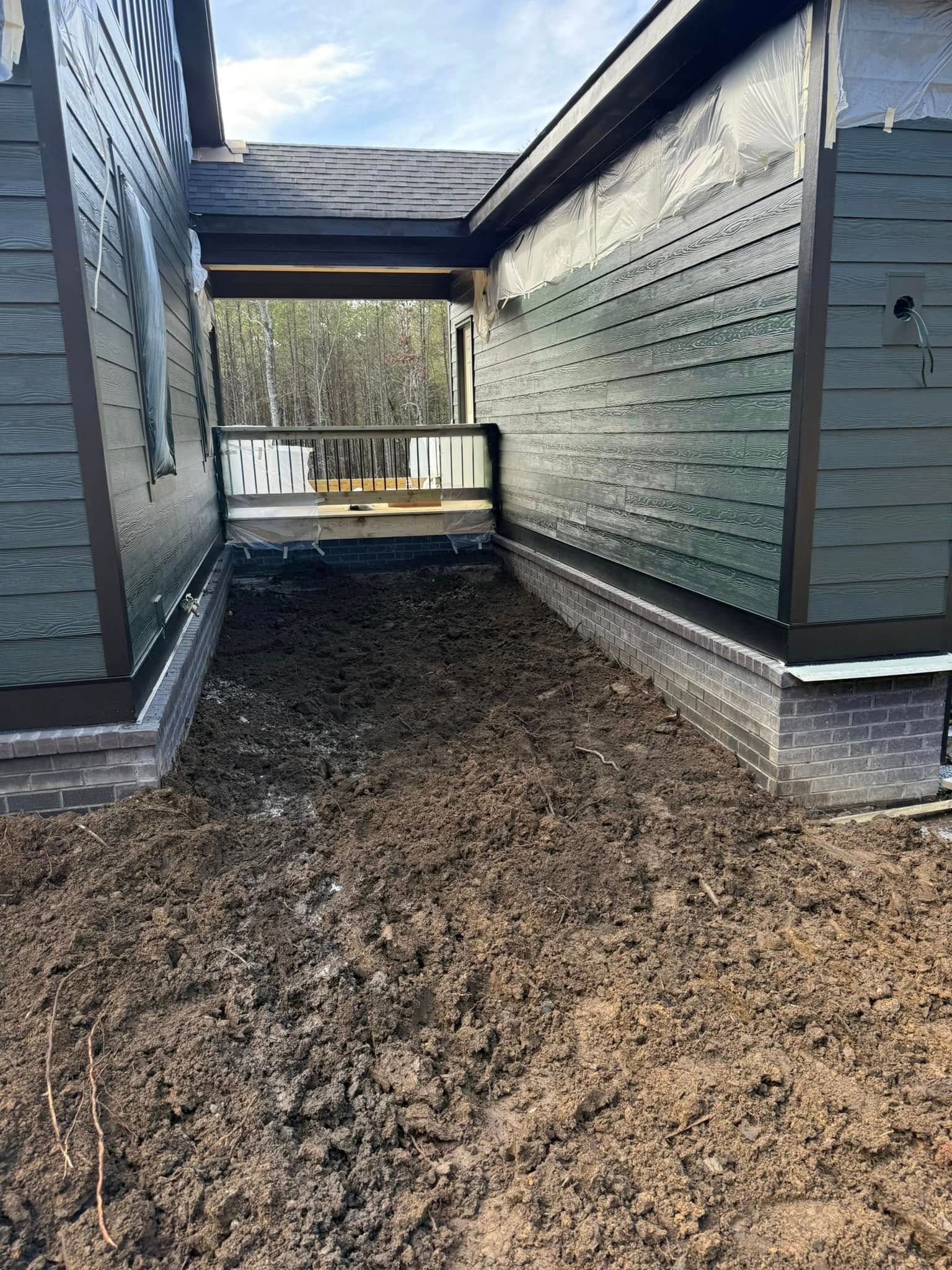 A house with a lot of dirt in front of it.