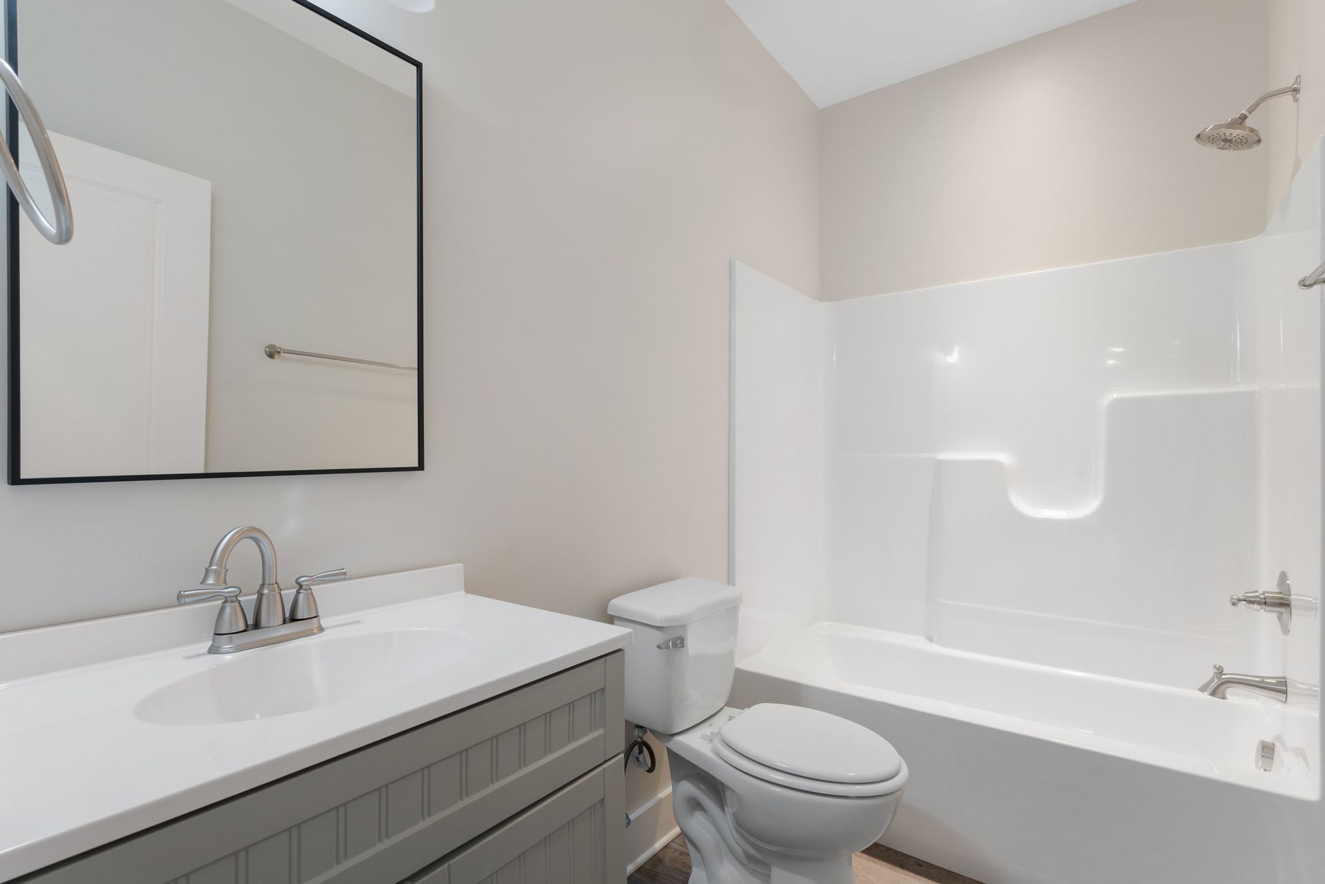 A bathroom with a toilet , sink , and bathtub.