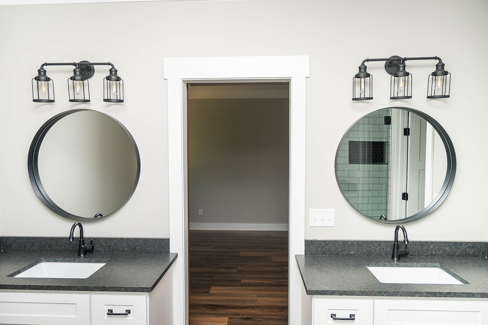 A bathroom with two sinks and two mirrors.
