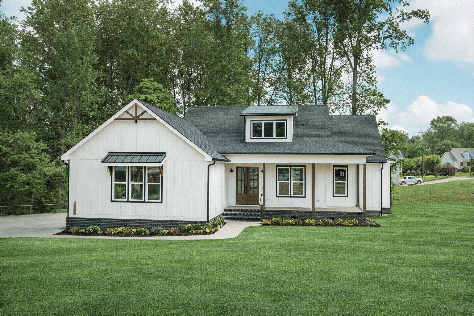 A white house with a black roof is under construction