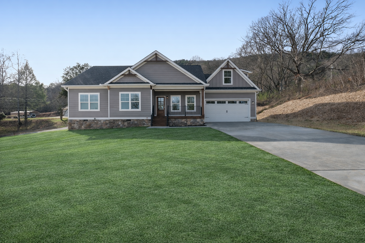 A house with a garage and a driveway in front of it