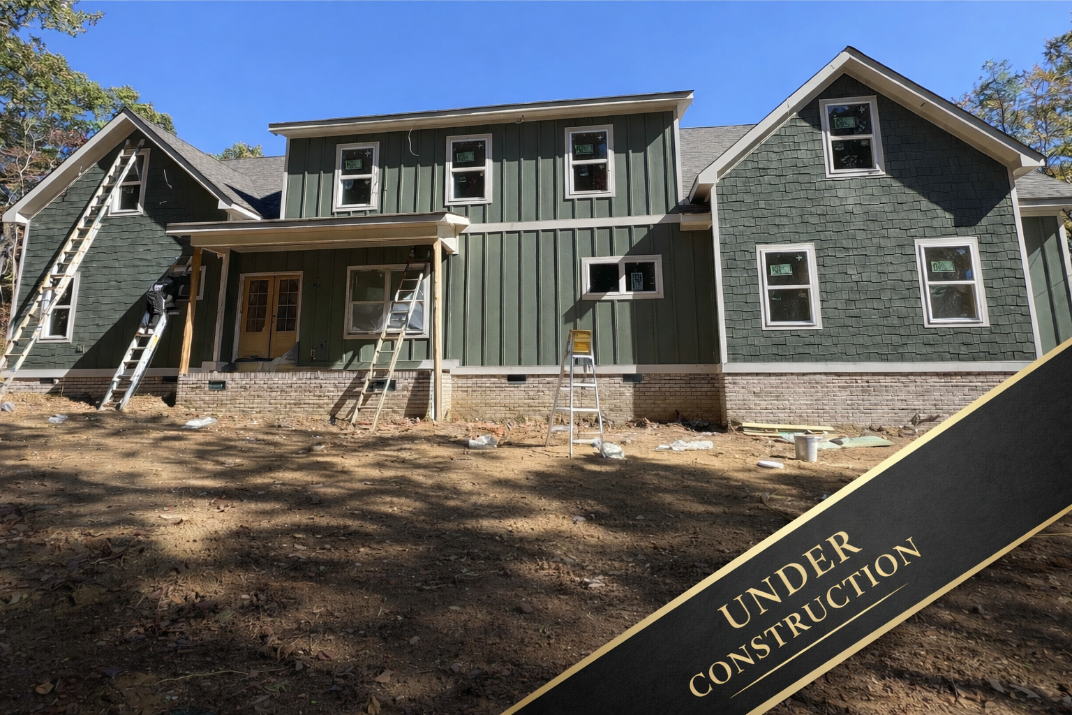 A large white house with a sign that says under construction