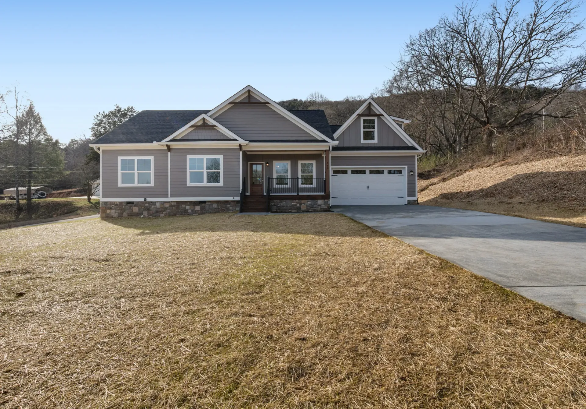 A house with a garage and a driveway in front of it