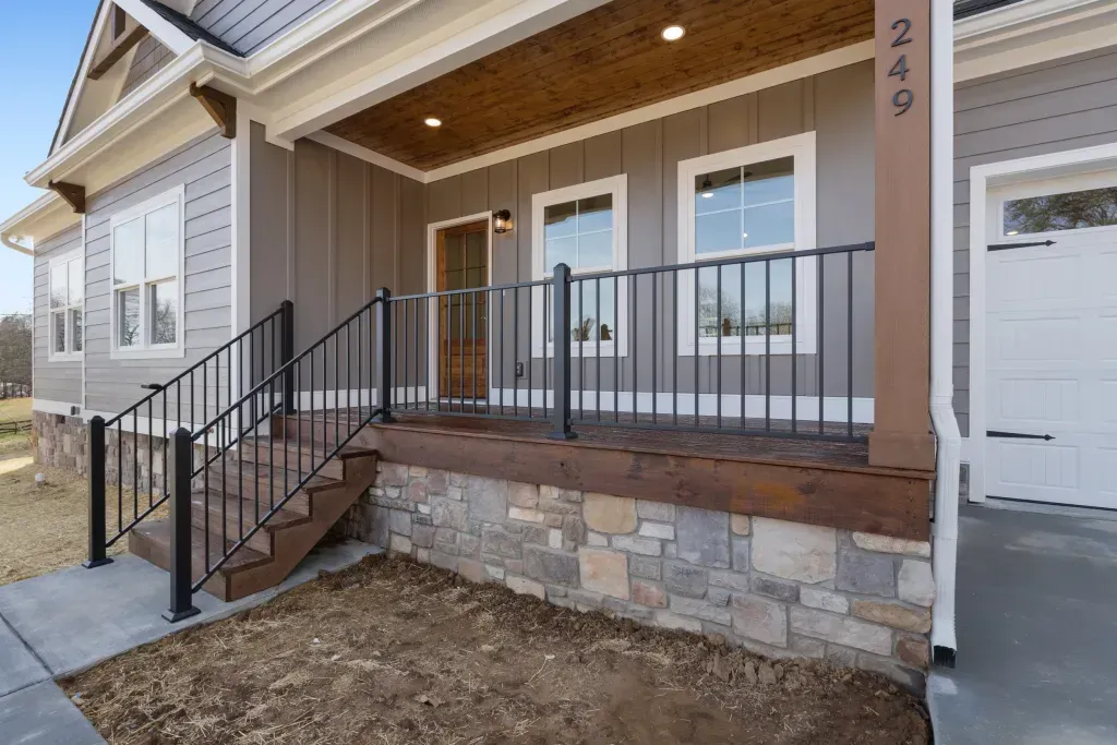 The front of a house with a porch and stairs