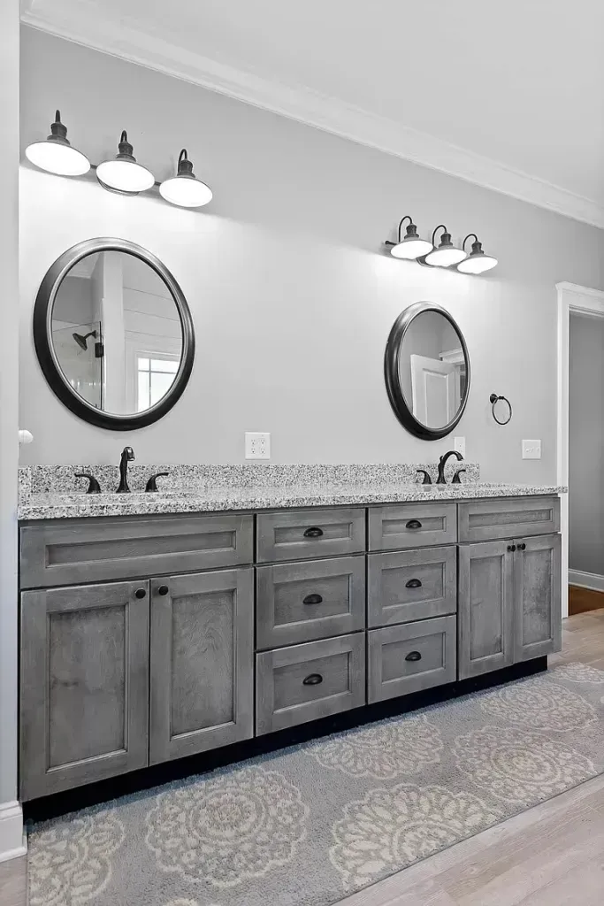 A bathroom with two sinks and two mirrors.