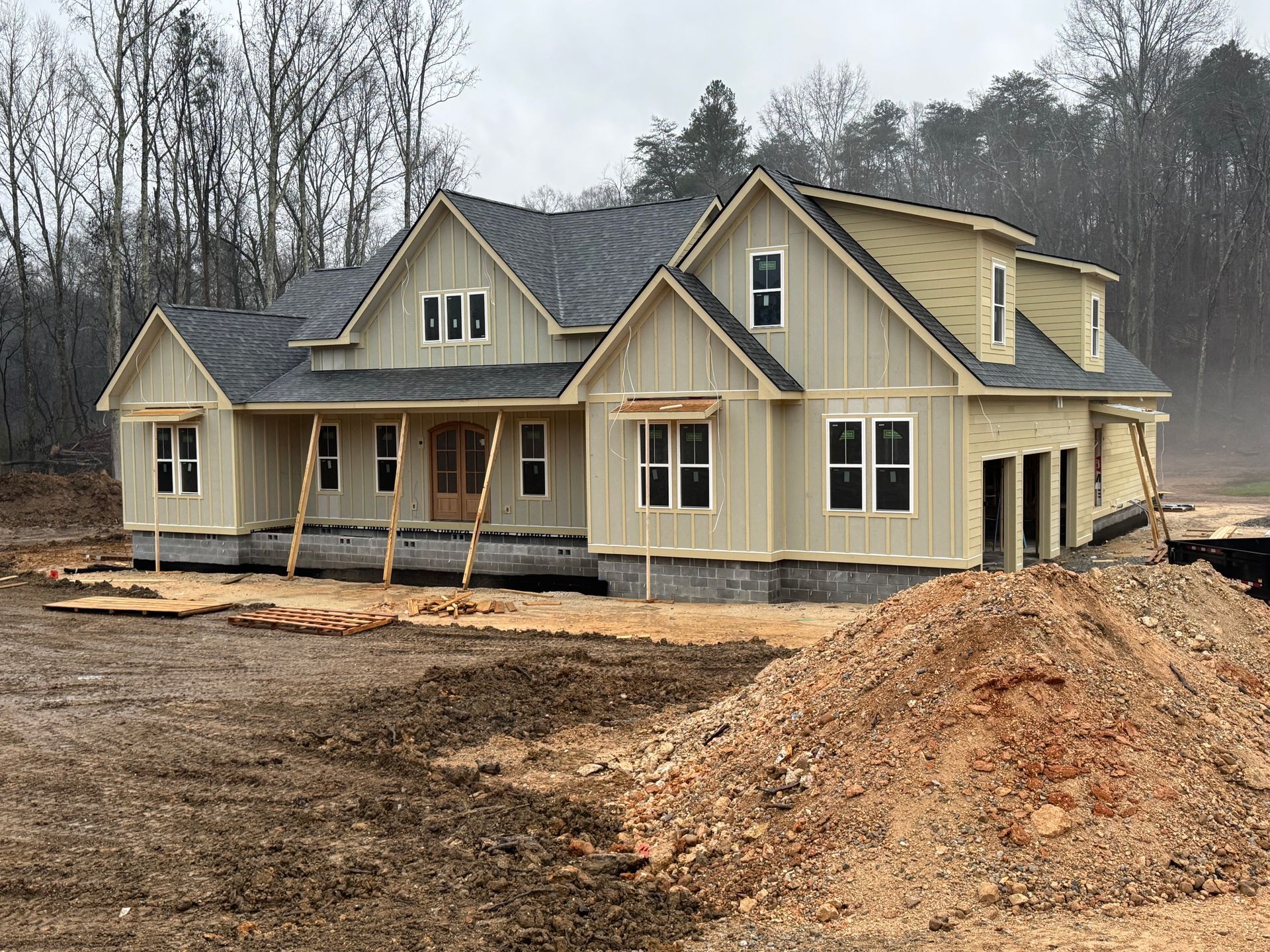 A large house with a sign that says under construction in front of it.