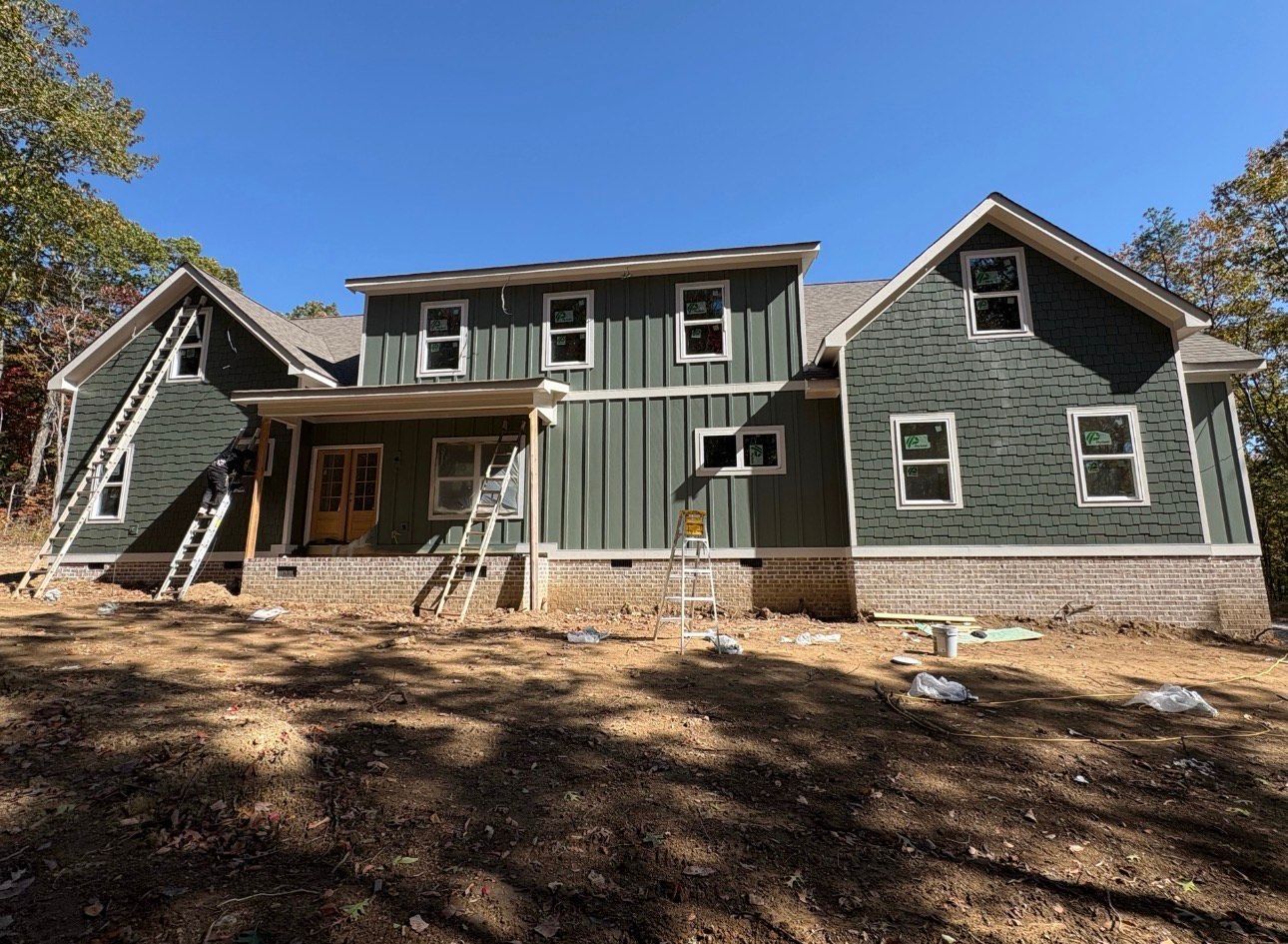 A large white house with a sign that says under construction