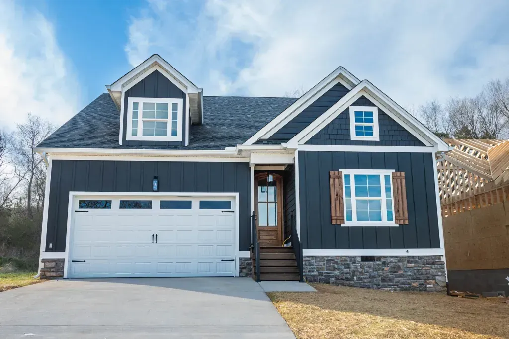 A large house with a blue siding and a white garage door.