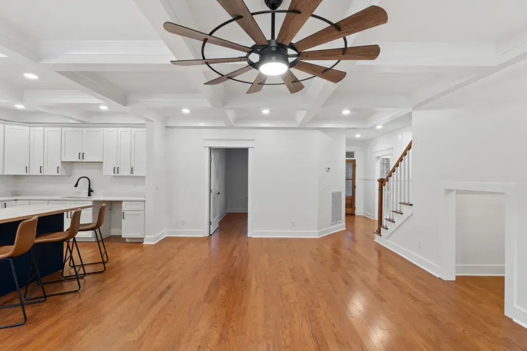 There is a ceiling fan in the middle of the room.