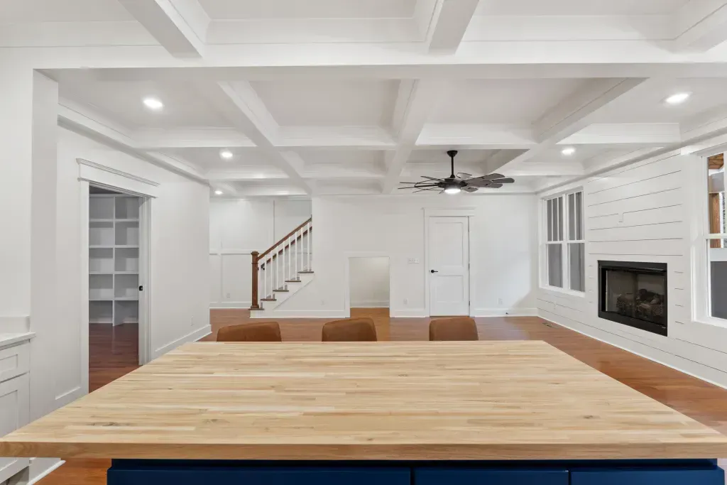 There is a wooden table in the middle of the room.