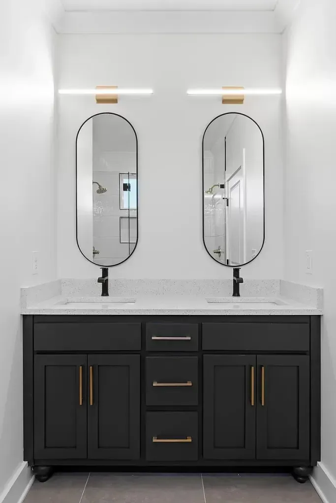 A bathroom with two sinks and two mirrors.