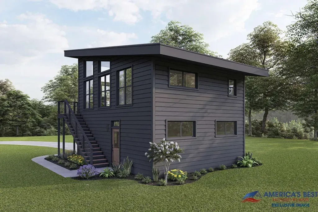 A small house with stairs leading up to the second floor is sitting on top of a lush green field.