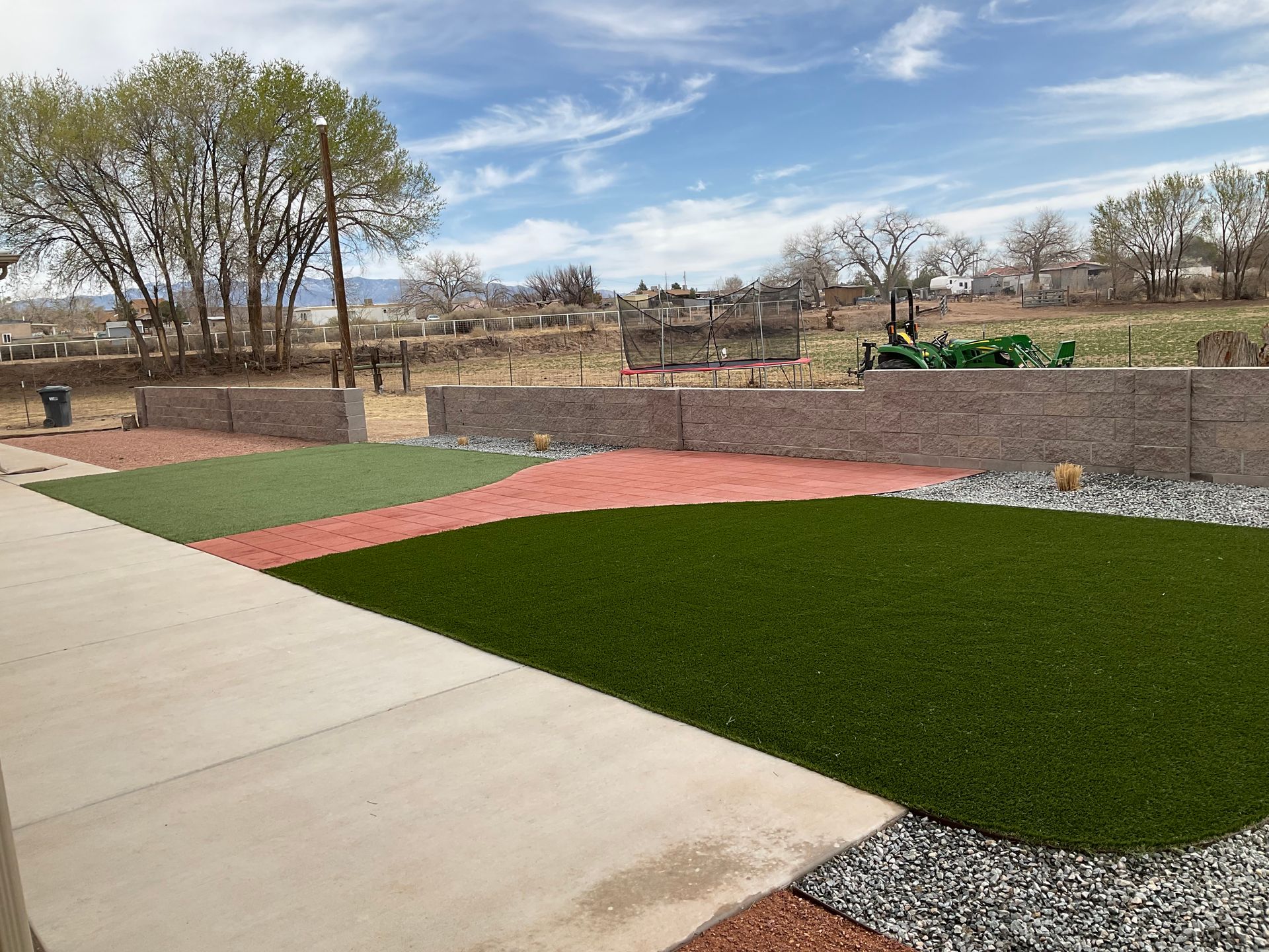 A lawn with a lot of grass and rocks in it