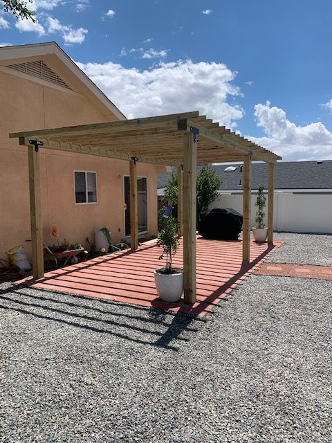 A house with a wooden pergola in front of it