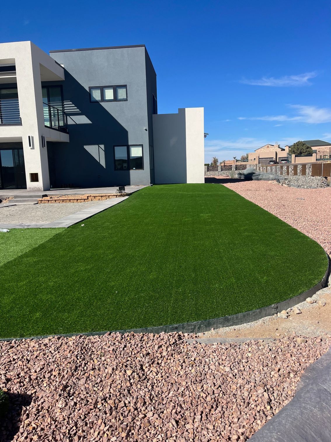 A large house with a lush green lawn in front of it.