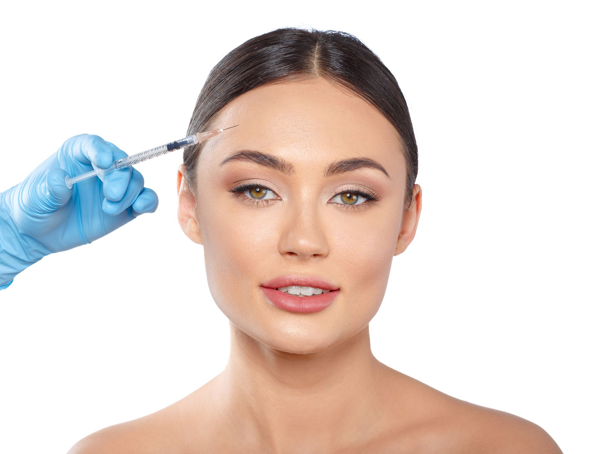 A woman is getting a botox injection in her forehead.