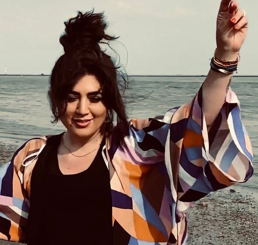 Eine Frau in einem bunten Kimono steht am Strand