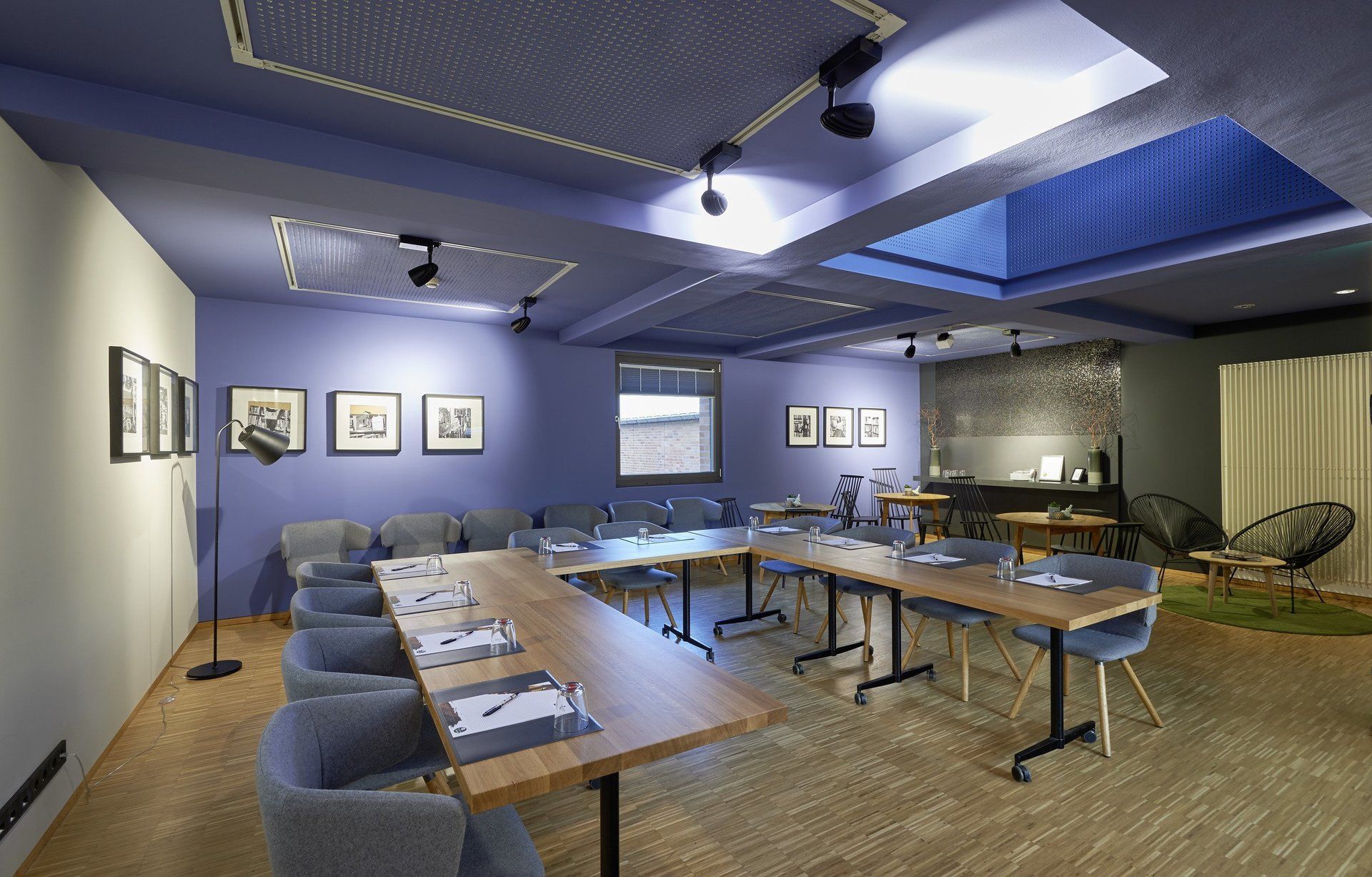 Ein Konferenzraum mit Tischen und Stühlen und einem Oberlicht in der Decke.