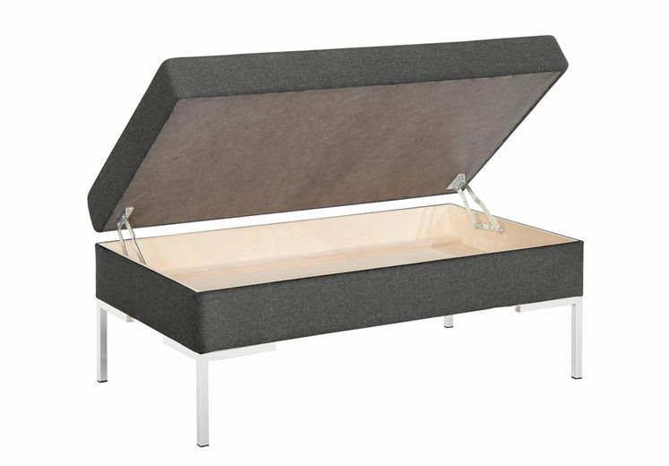 Eine graue Ottomane mit offenem Deckel auf weißem Hintergrund