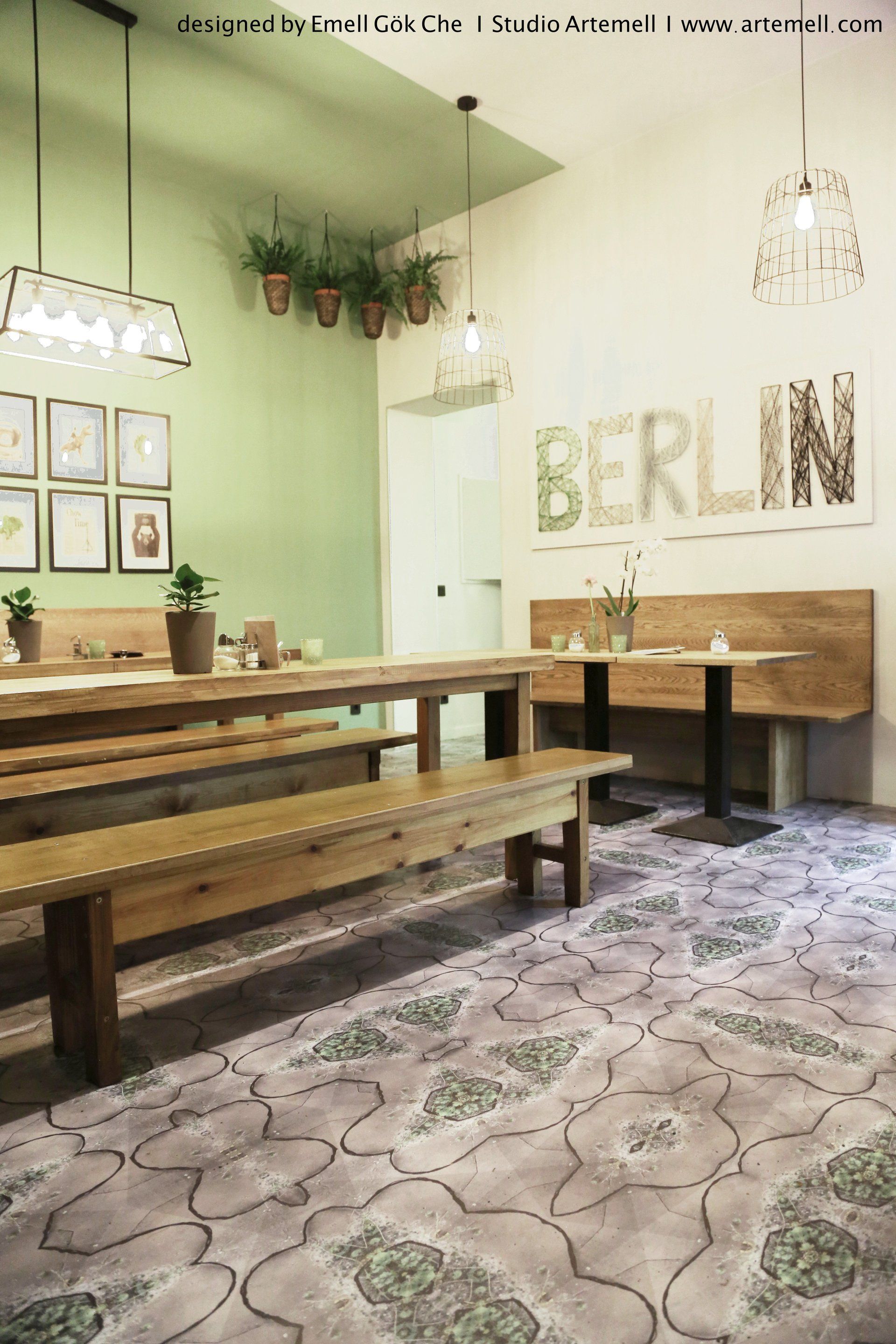 Ein Esszimmer mit Tischen und Bänken und einem Schild mit der Aufschrift „Berlin“ an der Wand.