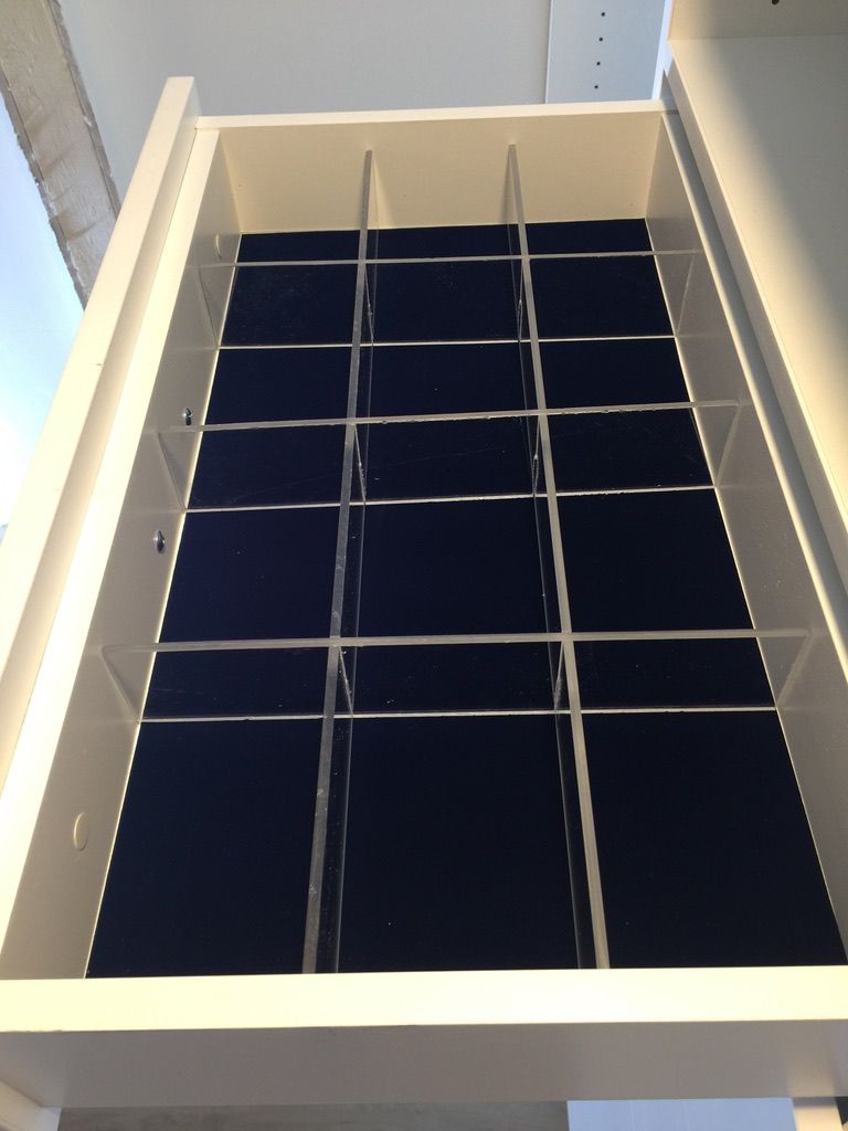 A white drawer with a black velvet divider