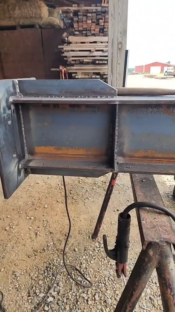 A piece of metal is sitting on top of a wooden table.