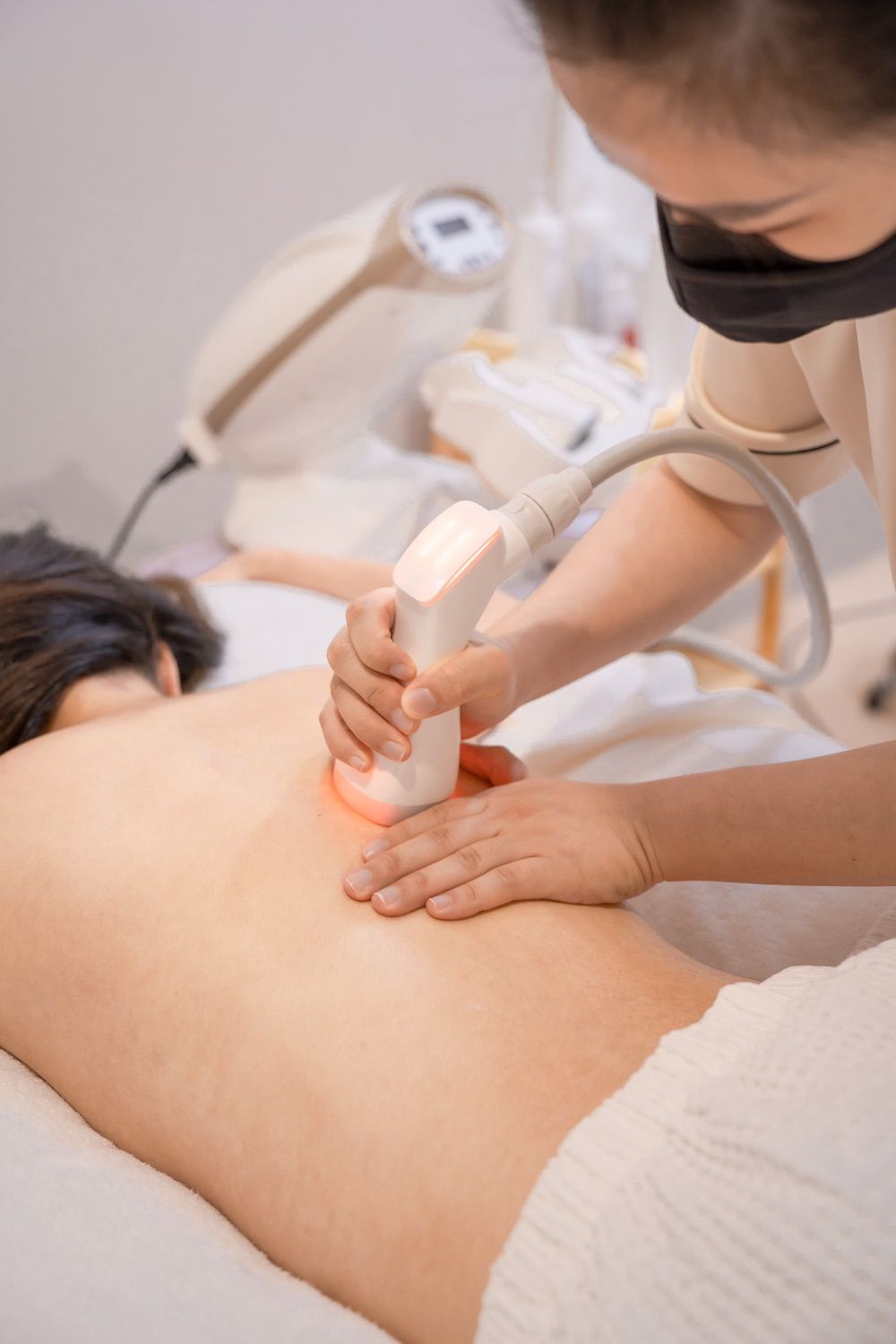 A woman is getting a massage on her back in a spa.