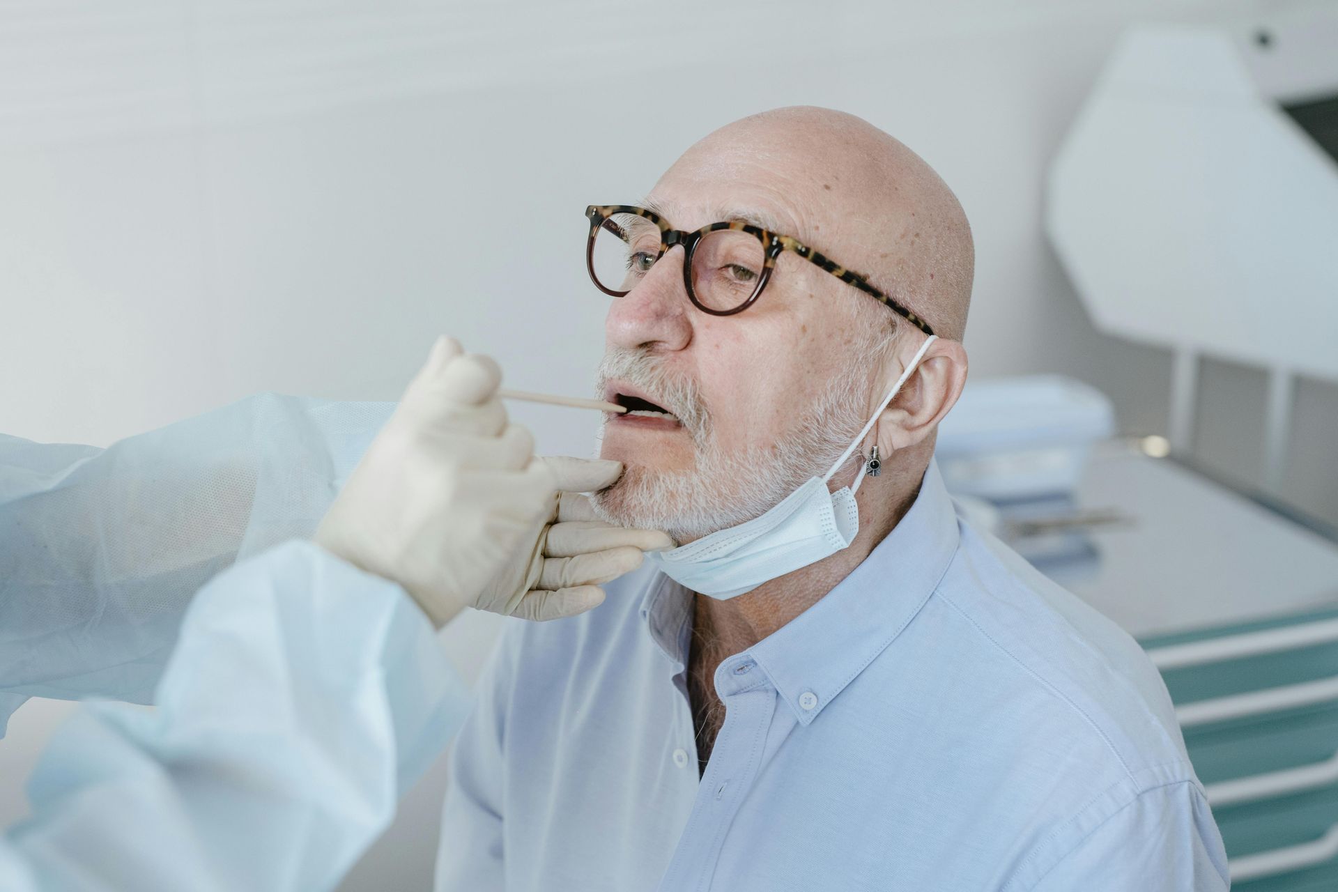 A man is getting a swab from his nose.