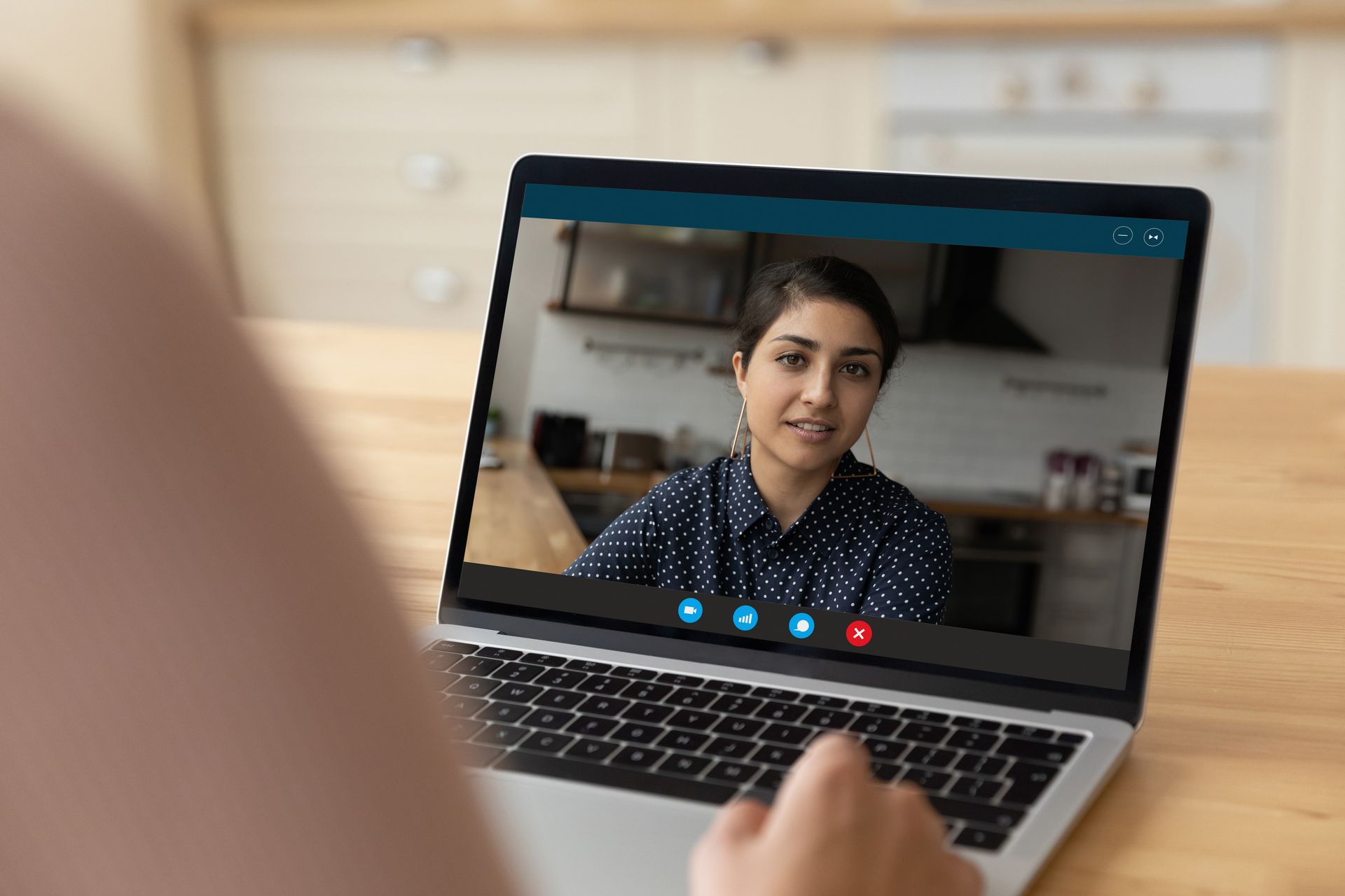 A woman is having a video call on a laptop computer.