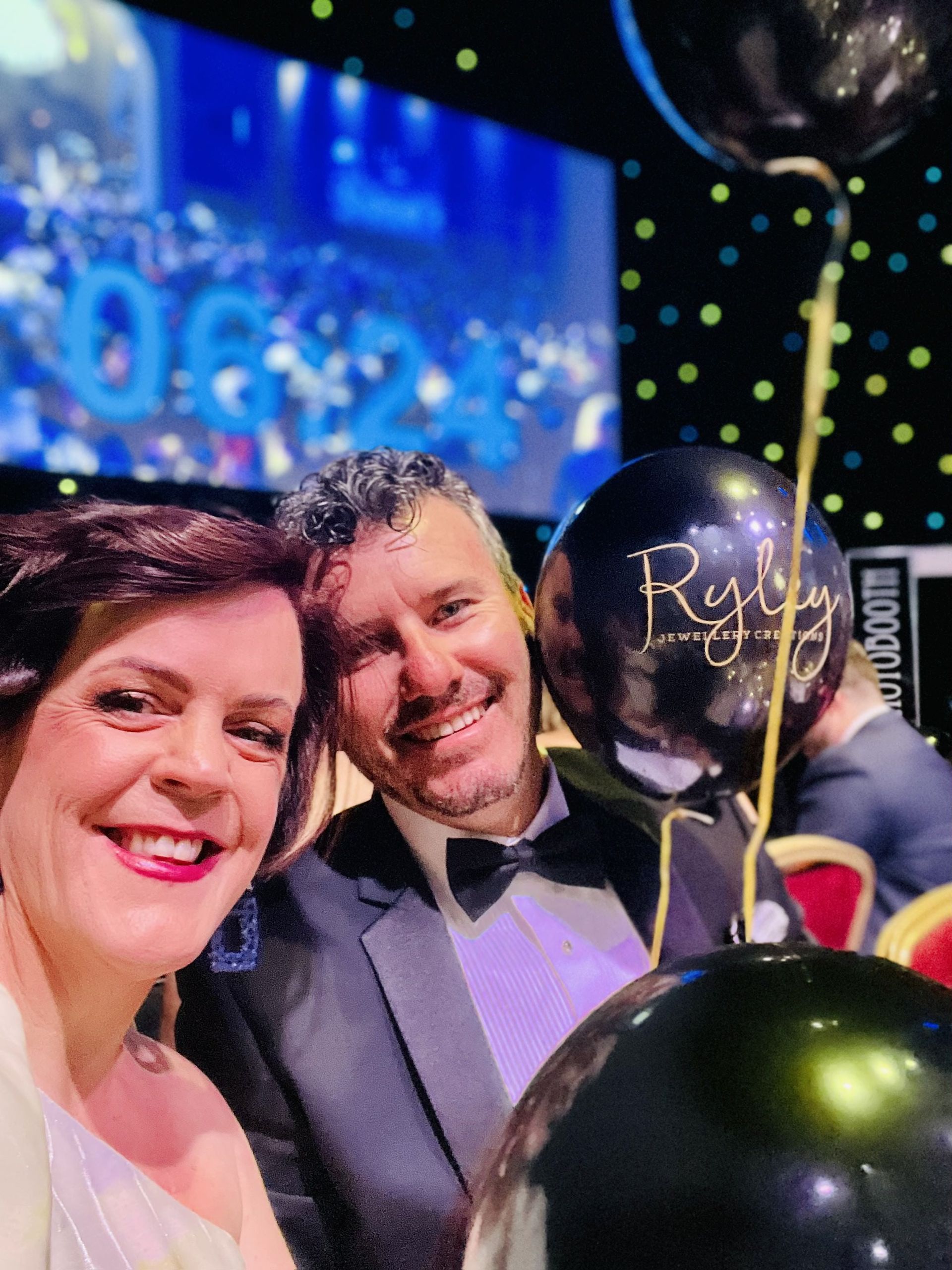 clayton menyweather and emma menyweather are posing for a picture with balloons in the background