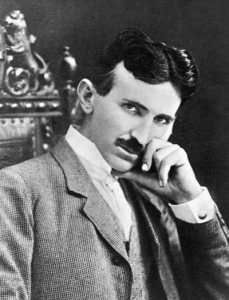 A man in a suit and tie is sitting in a chair with his hand on his chin.