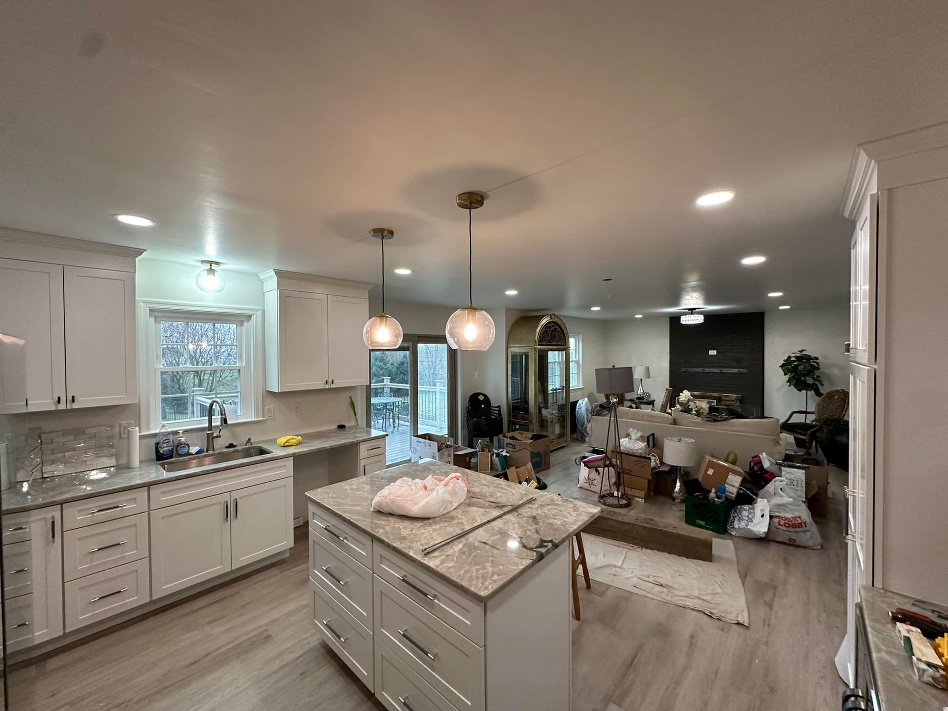 A kitchen with white cabinets and granite counter tops is being remodeled.