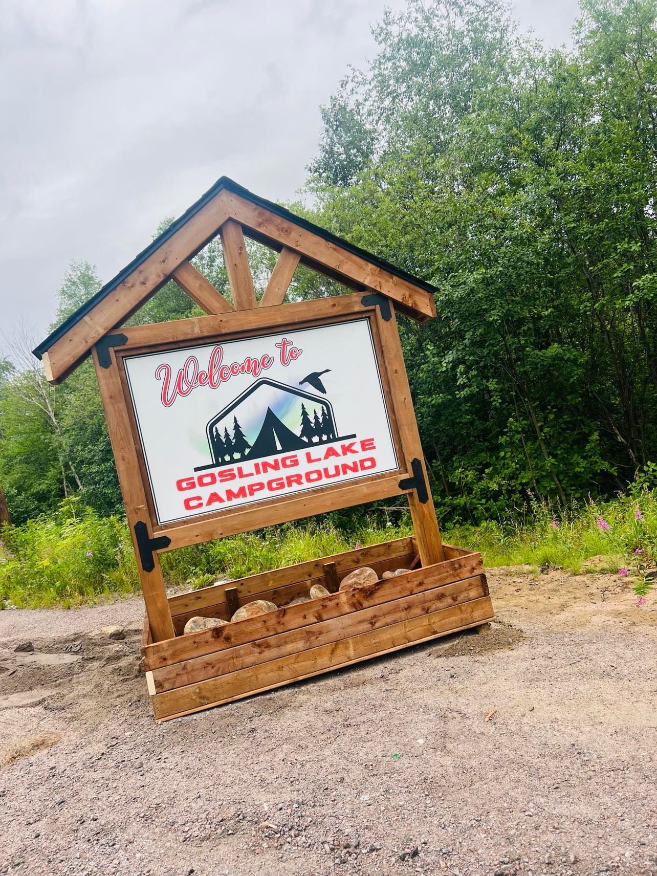 A wooden sign that says welcome to goblins lake campground