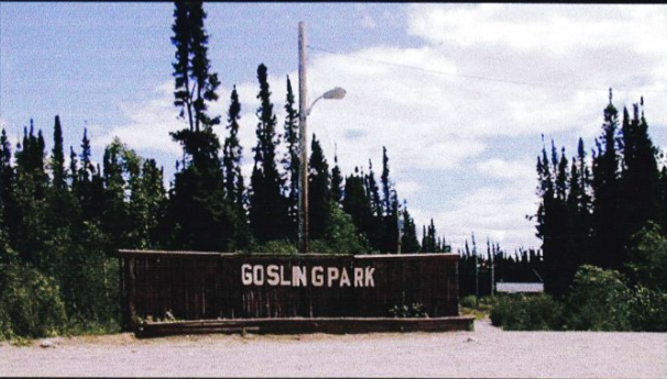 A sign for gosling park is surrounded by trees