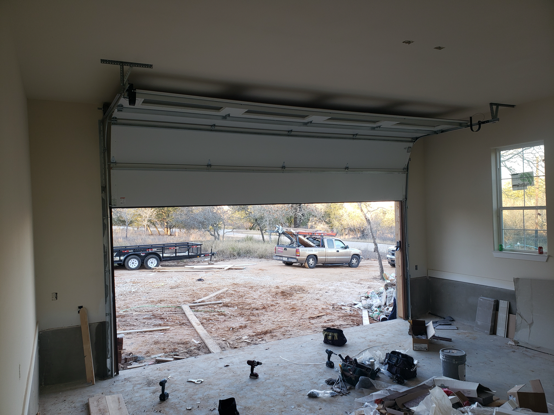 An open garage door with a truck parked in the background