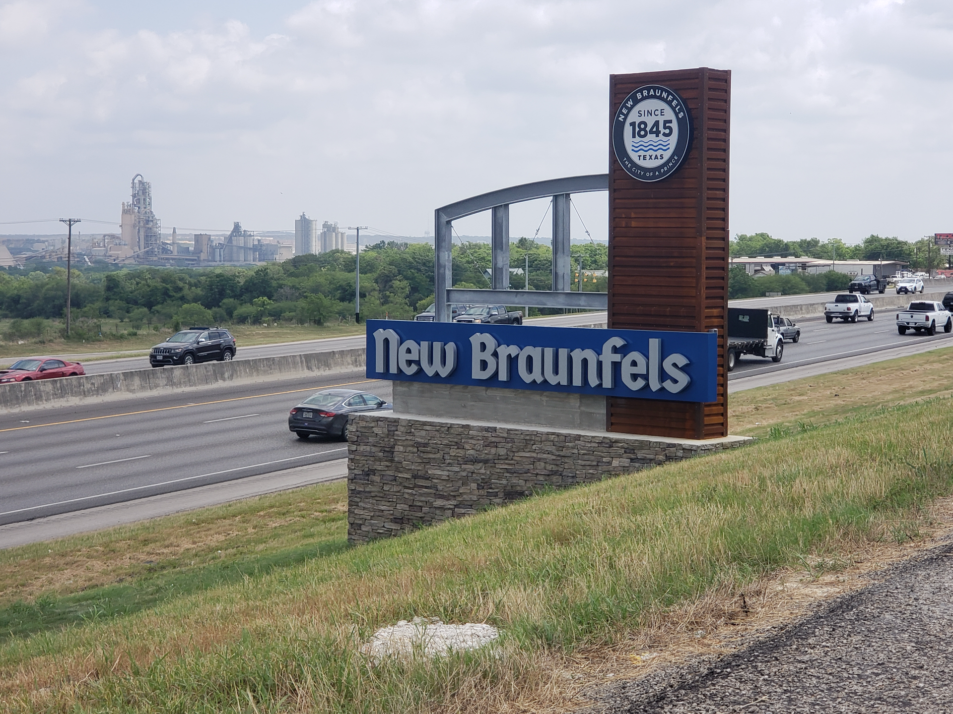 A sign for new braunfels is on the side of a highway