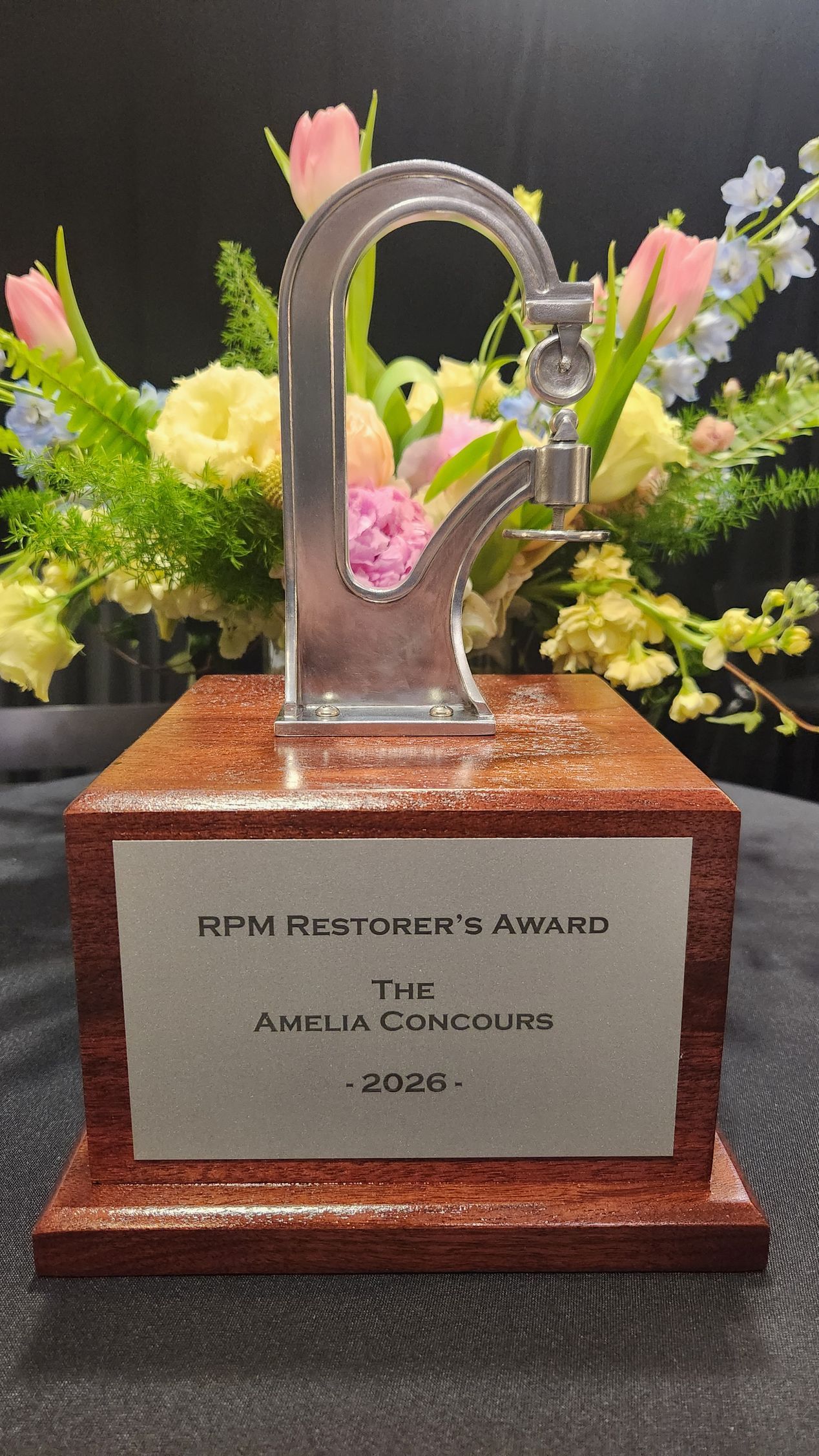 A trophy in front of a red porsche race car