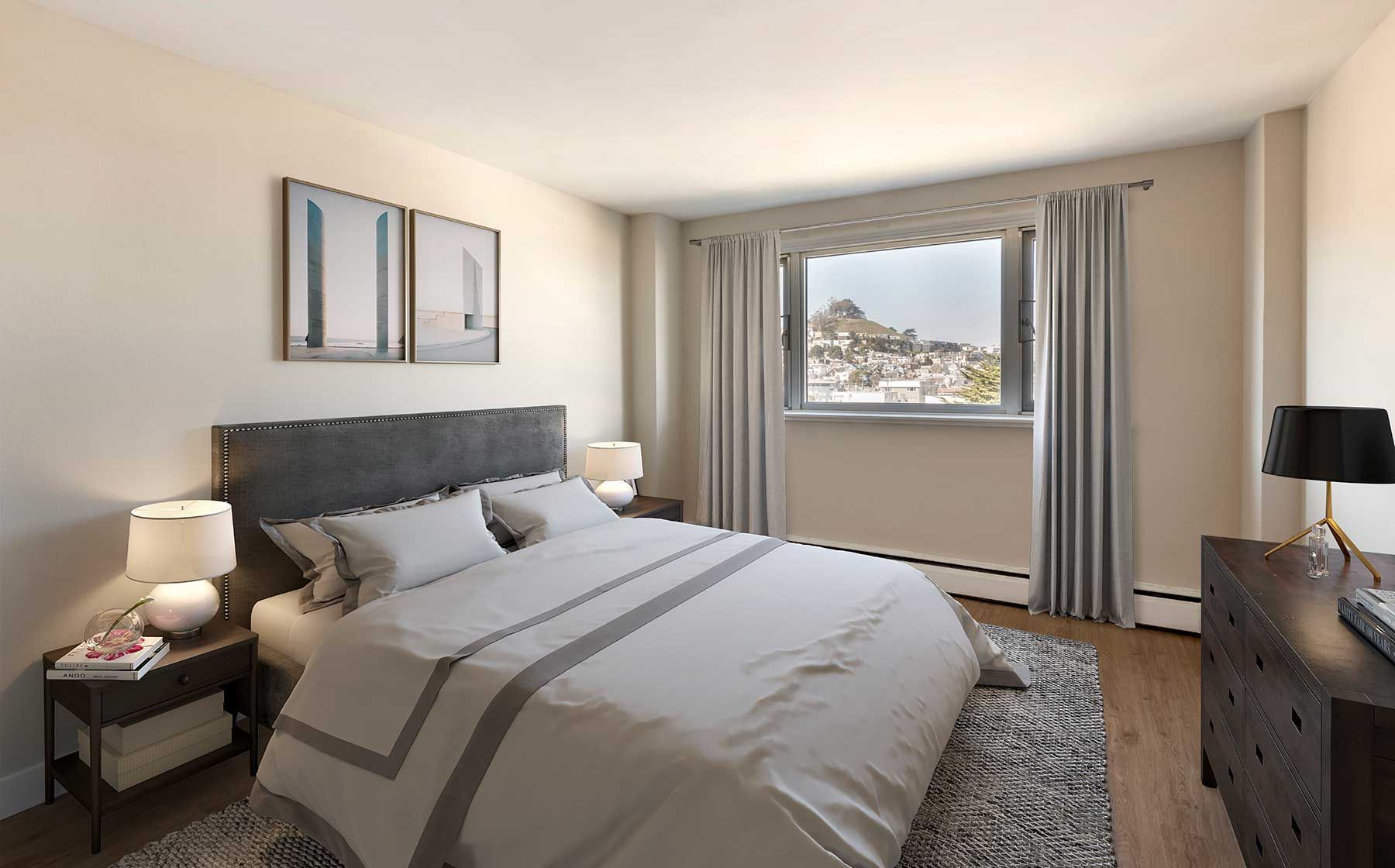 Bedroom with bed, nightstands, dresser, window with curtains, and artwork.