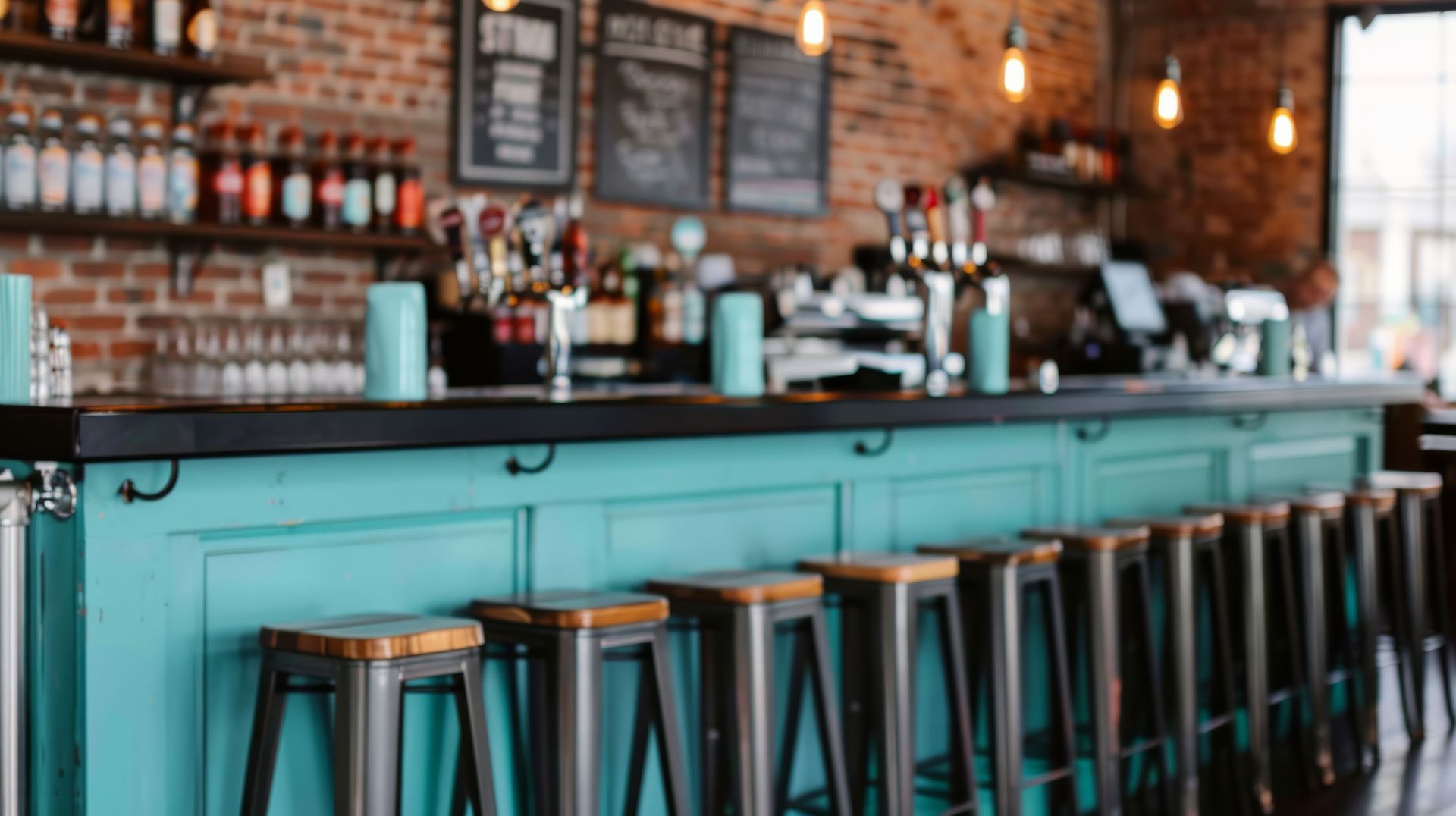 Contemporary bar counter with stools, painted bar front, exposed brick wall to backfitting.