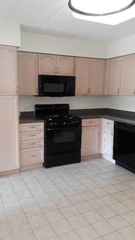 Kitchen With Black Stove — Elmwood Park, Illinois — Maria’s Cleaning Services at Elmwood Park