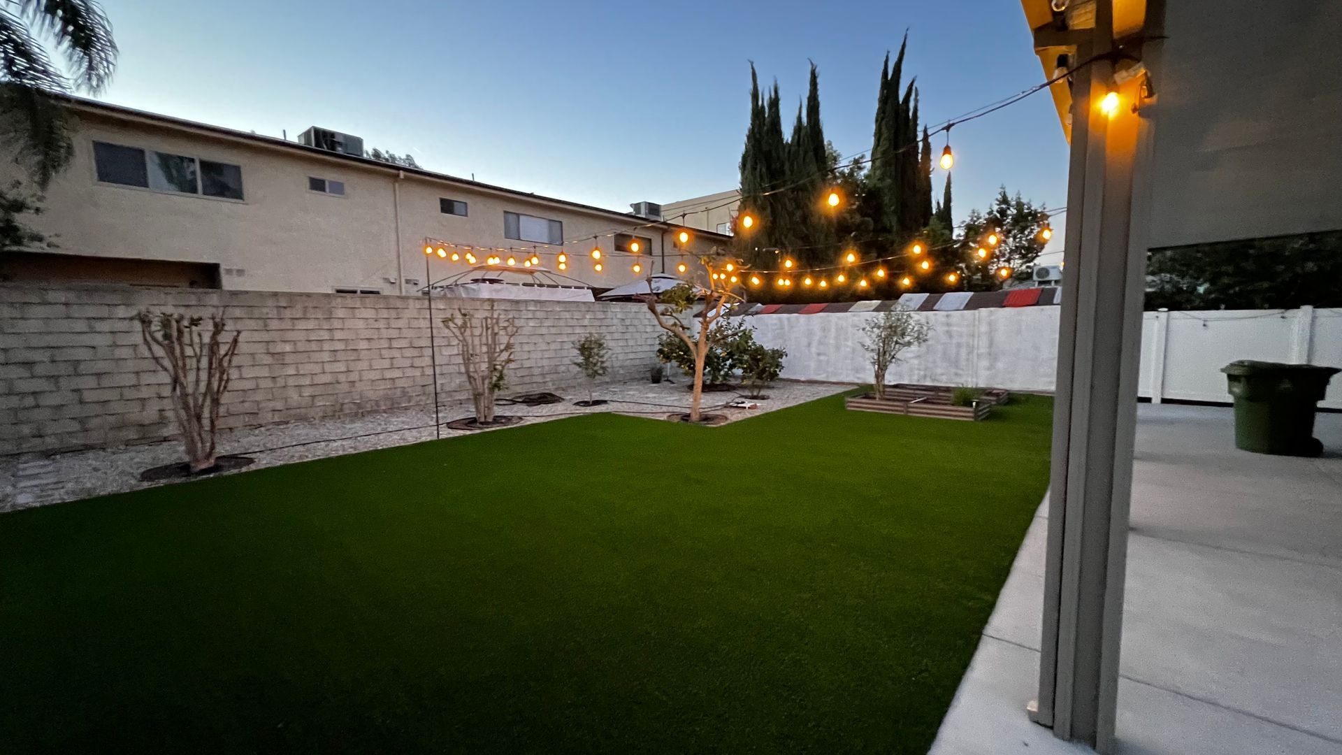 artificial grass in back yard with planters