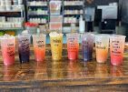 Row of colorful bottled drinks on a counter in a restaurant or café
