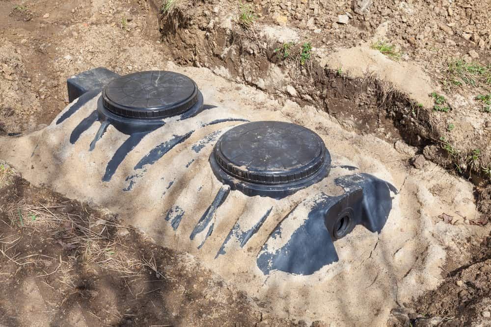 A Septic Tank is Sitting in the Dirt in a Hole — Tony Gordon Septic Tank Cleaning in Newee Creek, NSW