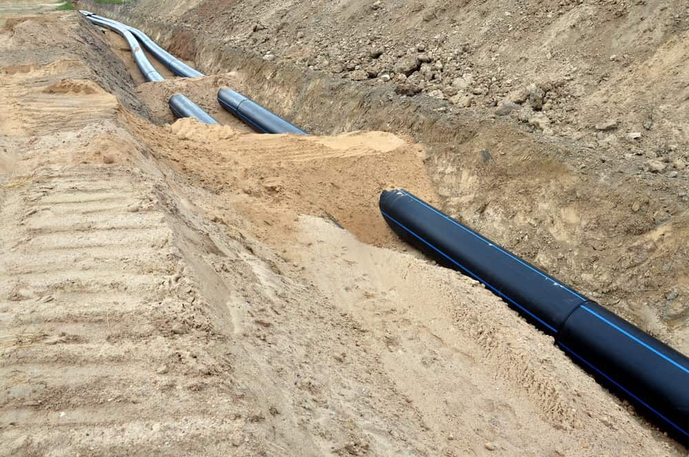 A Bunch of Pipes Are Laying in the Dirt — Tony Gordon Septic Tank Cleaning in Newee Creek, NSW