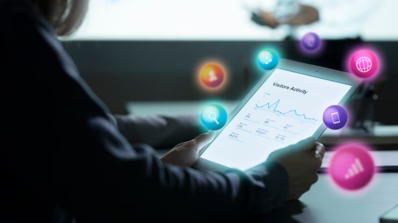 A person is holding a tablet with a graph on it.