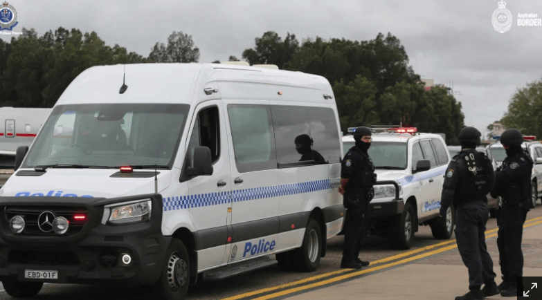 Heavy police convoy waiting to escort Sam Ibrahim