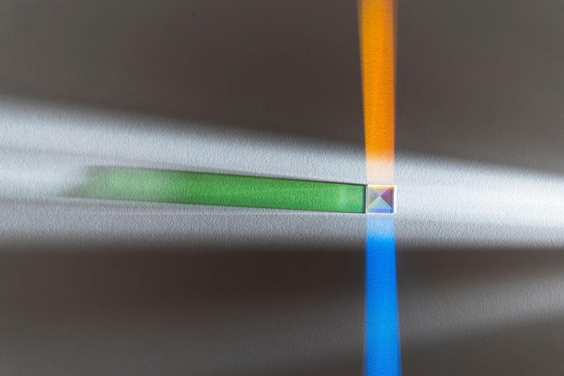 Light refracted by a prism, creating bands of orange and blue on a surface.