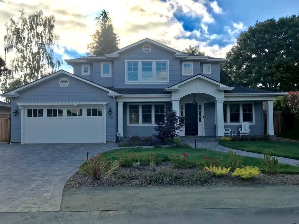 A large gray house with a white garage door