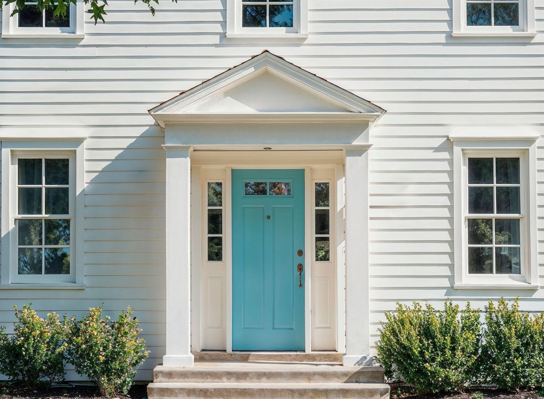 A white house with a blue door and windows