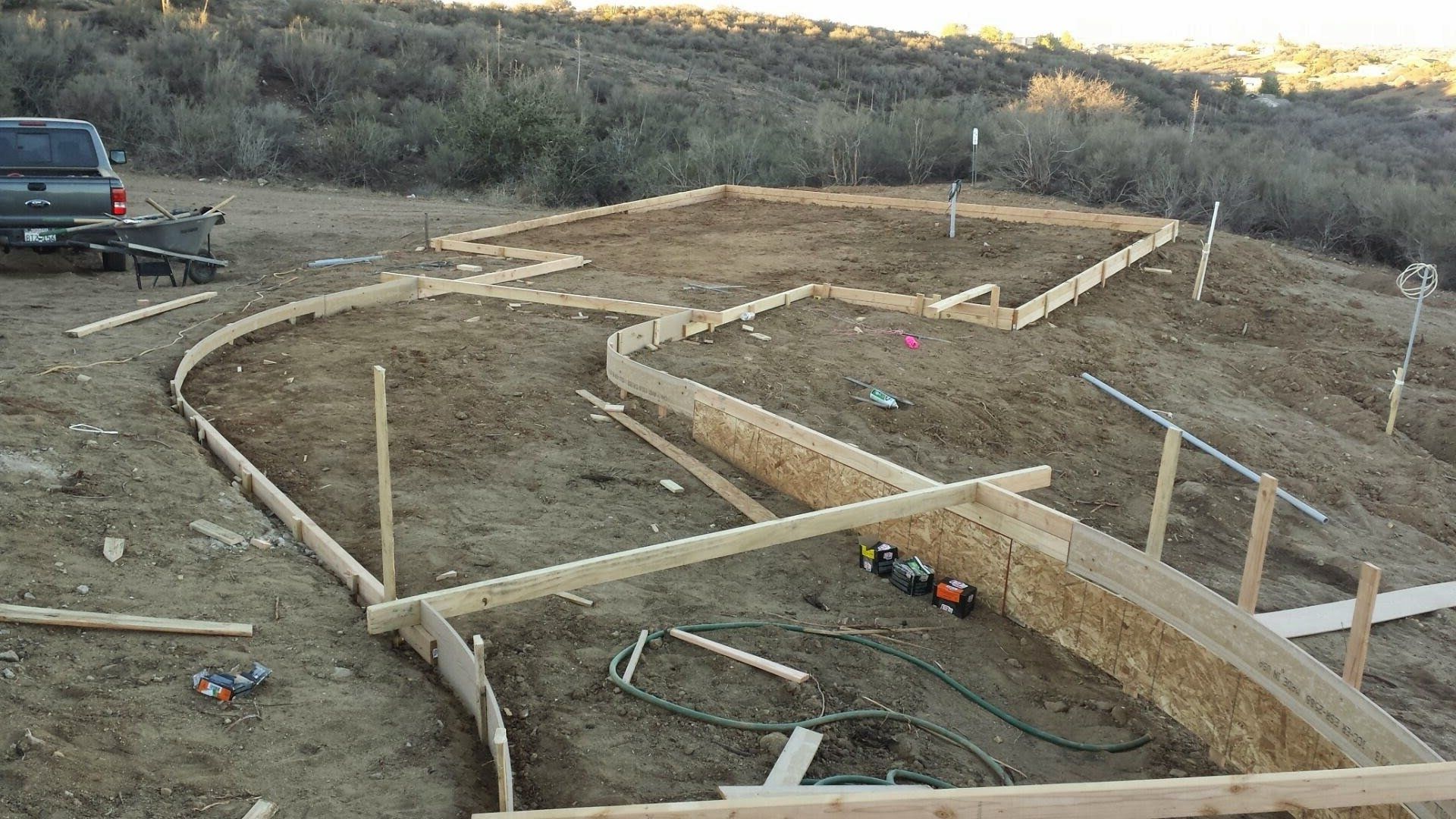 A truck is parked on the side of a dirt road.